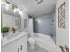 Renovated bathroom featuring patterned tile floor, blue tiled walls, and a modern sink at 4112 W Lawn Ave, Tampa, FL 33611