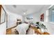 Bright bedroom with a ceiling fan, hardwood floors, and a serene view out the window at 4112 W Lawn Ave, Tampa, FL 33611