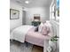 Relaxing bedroom with stylish decor, hardwood floors, and a ceiling fan for ultimate comfort at 4112 W Lawn Ave, Tampa, FL 33611