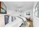 Comfortable bedroom features a ceiling fan and hardwood floors, complemented by ample natural light at 4112 W Lawn Ave, Tampa, FL 33611