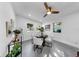 Bright dining room with stylish light fixtures and four windows that provide ample natural light at 4112 W Lawn Ave, Tampa, FL 33611