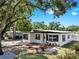 Inviting single-story home with black trim windows and a beautiful landscaped yard with stone and plants at 4112 W Lawn Ave, Tampa, FL 33611