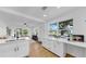 Modern kitchen with quartz countertops, white cabinetry, and a view to the bright and airy living room at 4112 W Lawn Ave, Tampa, FL 33611