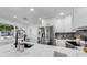 Modern kitchen with stainless steel appliances, white cabinetry and quartz countertops offer a clean, bright space at 4112 W Lawn Ave, Tampa, FL 33611