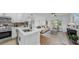 Modern kitchen with stainless steel appliances and white cabinets, seamlessly connected to the living area at 4112 W Lawn Ave, Tampa, FL 33611