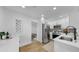 Bright, modern kitchen features stainless steel appliances, white cabinets and a breakfast bar with seating at 4112 W Lawn Ave, Tampa, FL 33611