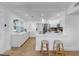 Bright kitchen with white cabinetry, an island with seating and stainless steel appliances, offering a modern design at 4112 W Lawn Ave, Tampa, FL 33611