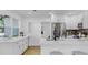 Bright kitchen featuring white cabinets, stainless steel appliances, and a breakfast bar with seating at 4112 W Lawn Ave, Tampa, FL 33611