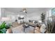 Open-concept living room with hardwood floors, modern furnishings, and abundant natural light at 4112 W Lawn Ave, Tampa, FL 33611