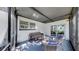 Comfortable covered patio featuring modern outdoor furniture and sliding glass doors to the backyard at 4112 W Lawn Ave, Tampa, FL 33611