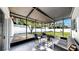 Relaxing screened-in patio with comfortable seating, perfect for enjoying the outdoor breeze and serene backyard views at 4112 W Lawn Ave, Tampa, FL 33611