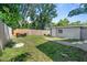 Spacious backyard with grassy area and dining furniture at 4460 67Th N St, St Petersburg, FL 33709