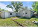 Large backyard with grass, partial brick walkway and detached shed at 4460 67Th N St, St Petersburg, FL 33709