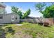 Spacious backyard featuring a grassy area, fence, and seating area at 4460 67Th N St, St Petersburg, FL 33709