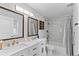 Bathroom featuring double vanity, framed mirrors, modern fixtures, and a tiled shower and tub at 4460 67Th N St, St Petersburg, FL 33709