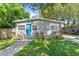 Charming home with a blue front door, landscaped garden, and inviting walkway at 4460 67Th N St, St Petersburg, FL 33709