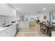 Modern kitchen with white cabinets, stainless steel appliances and view into the living room at 4460 67Th N St, St Petersburg, FL 33709