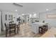 Modern kitchen and dining area with stainless steel appliances, breakfast bar and wood-look flooring at 4460 67Th N St, St Petersburg, FL 33709
