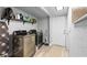 Well-organized laundry room with modern washer and dryer, shelving, and ample storage at 4460 67Th N St, St Petersburg, FL 33709