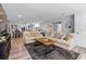 Bright and airy living room featuring wood-look flooring, comfortable seating, and open floor plan at 4460 67Th N St, St Petersburg, FL 33709