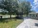 Fenced backyard featuring a trampoline, a covered patio area, and a scenic view of the lake at 4522 Lisette Cir, Brooksville, FL 34604