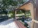 Relax in this backyard patio area with comfortable seating, a gazebo, and a view of the lake at 4522 Lisette Cir, Brooksville, FL 34604