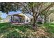Lush backyard featuring dining area, patio, and mature trees at 4522 Lisette Cir, Brooksville, FL 34604