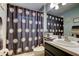 Well-lit bathroom featuring a shower with decorative curtains and modern fixtures at 4522 Lisette Cir, Brooksville, FL 34604