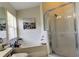 Bathroom showcasing a glass-enclosed shower, tiled walls, and a relaxing bathtub at 4522 Lisette Cir, Brooksville, FL 34604