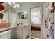 Bathroom featuring floral shower curtain, vanity, and view into bedroom at 4522 Lisette Cir, Brooksville, FL 34604