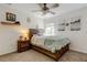 Cozy bedroom with a wooden bed frame, ceiling fan, and soft, neutral decor at 4522 Lisette Cir, Brooksville, FL 34604