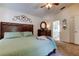Comfortable bedroom with a ceiling fan, wood dresser, and natural light from the windows at 4522 Lisette Cir, Brooksville, FL 34604