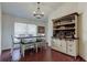 Well-appointed dining room with stylish furniture, light fixture, and a charming hutch for elegant entertaining at 4522 Lisette Cir, Brooksville, FL 34604