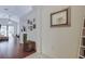 Inviting hallway with wood floors and decorative accents leads to a bright, open living area at 4522 Lisette Cir, Brooksville, FL 34604