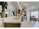Open kitchen featuring a breakfast bar, modern appliances, and a view of the adjacent dining area at 4522 Lisette Cir, Brooksville, FL 34604