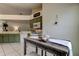Cozy breakfast nook adjacent to kitchen features green cabinets and white appliances creating a warm and inviting atmosphere at 4522 Lisette Cir, Brooksville, FL 34604