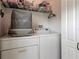 Functional laundry area with washer, dryer, and storage shelves, optimizing space for household chores at 4522 Lisette Cir, Brooksville, FL 34604