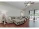 Bright living room boasts a vaulted ceiling, rich wood floors, and large sliding glass doors at 4522 Lisette Cir, Brooksville, FL 34604