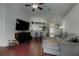 Inviting living room with a comfortable sectional, a large TV, and an open view to the kitchen at 4522 Lisette Cir, Brooksville, FL 34604