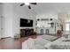 Open-concept living room featuring modern decor, a TV, and a view into the kitchen area at 4522 Lisette Cir, Brooksville, FL 34604