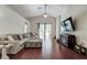Spacious living room featuring high ceilings, wood floors, and a comfortable, stylish sectional sofa at 4522 Lisette Cir, Brooksville, FL 34604