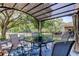 Beautifully covered patio with dining set and scenic backyard and water views at 4522 Lisette Cir, Brooksville, FL 34604