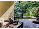 Covered patio with comfortable seating offers peaceful views of the backyard, trampoline, and serene water setting at 4522 Lisette Cir, Brooksville, FL 34604
