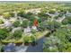 Aerial view of a private pool surrounded by a lush backyard and the lake at 4639 Cabbage Palm Dr, Valrico, FL 33596