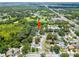 An aerial view of the property showcasing its tranquil setting adjacent to a pond and verdant landscapes at 4639 Cabbage Palm Dr, Valrico, FL 33596