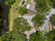 Bird's eye view shows location of property next to pond with pool, surrounded by mature trees and green lawns at 4639 Cabbage Palm Dr, Valrico, FL 33596