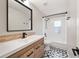 Bathroom with a modern vanity and stylish shower-tub combo with black hardware at 4639 Cabbage Palm Dr, Valrico, FL 33596