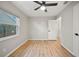Bright bedroom featuring wood flooring, a ceiling fan, a window offering plenty of natural light, and neutral wall paint at 4639 Cabbage Palm Dr, Valrico, FL 33596