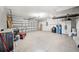 Spacious garage with a side-mounted garage door opener, concrete flooring, and fluorescent lighting at 4639 Cabbage Palm Dr, Valrico, FL 33596