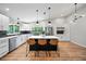 Open-concept kitchen with a large marble island, white cabinets, stainless appliances, and natural light at 4639 Cabbage Palm Dr, Valrico, FL 33596